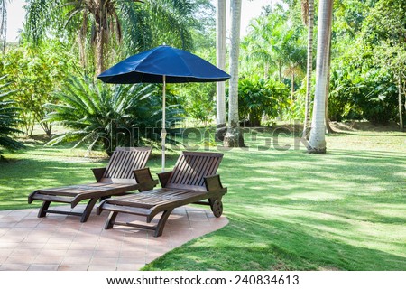 Pool chairs with umbrella in a relaxing setting