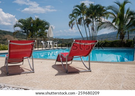 Swimming pool chairs in a relaxing setting