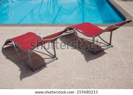Swimming pool chairs in a relaxing setting