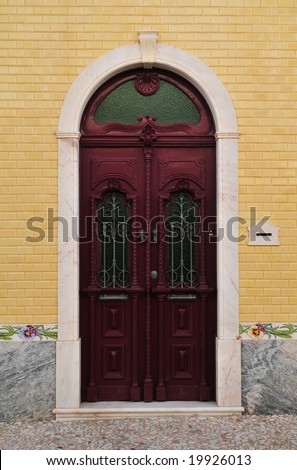 Wooden front door with marble decoration - the picture was taken in Borba (Portugal), one of the well-known marble towns.