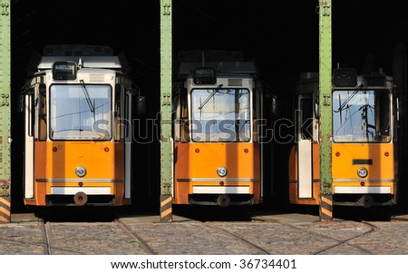 Three articulated yellow tram in shed at Budapest (Hungary).