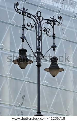 Antique wrought iron street lamp in front of modern building in Budapest  (Hungary).