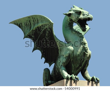 One of the four bronze dragons on the Dragon Bridge in Ljubljana, isolated on blue.