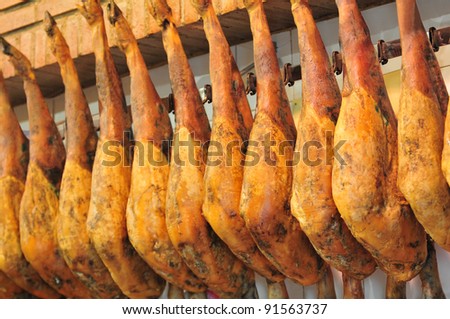 Legs of spanish serrano ham in the market place.