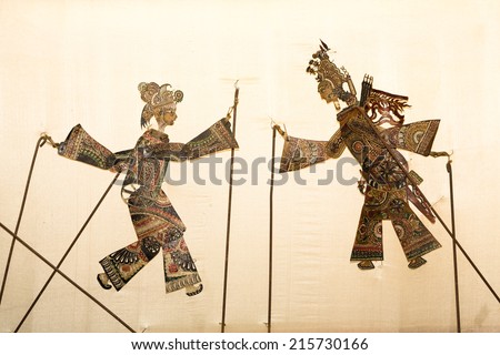 figures of a shadow play on a wall