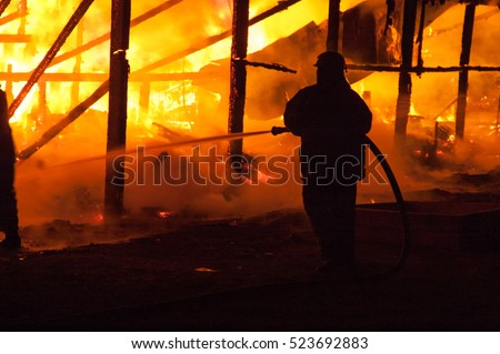Firefighters extinguish a house