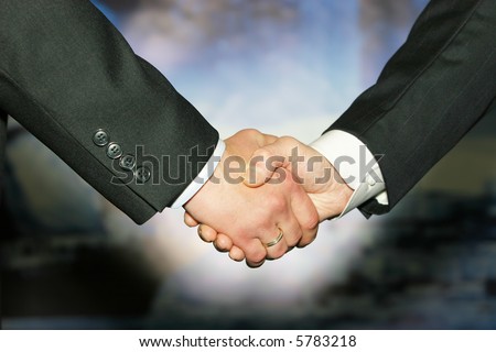 Business handshake over abstract blue background