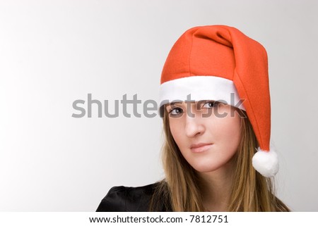 Beautiful stylish woman in red santa\'s cap