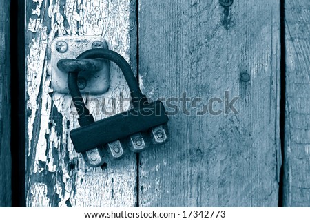 Grunge wooden background and old coded lock with 666 figures on it.