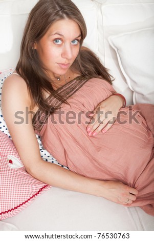 Pregnant woman laying on the sofa.