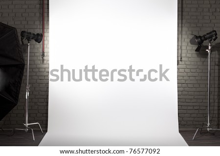 Photo of an empty white background in photographic studio with modern lighting equipment. Empty space for your text or objects