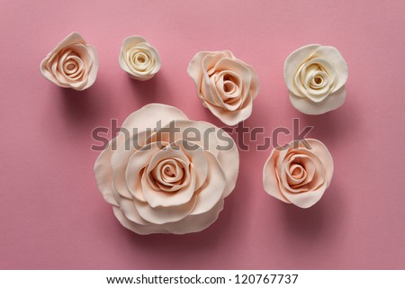 Fondant roses on a pink background