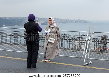 ISTANBUL, TURKEY - NOVEMBER 16: Common people shooting photographs at the 34th annual Euroasia Marathon on November 16, 2014 in Istanbul, Turkey.