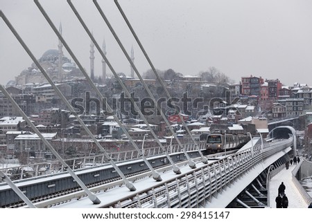 Metro train at the Halic Bridge in winter