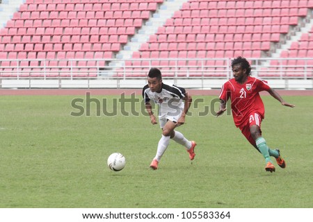 BANGKOK THAILAND - JUNE 17 : Unidentified players in Football Friendly Match 2012 (U22) between Vietnam (White) vs Maldive (Red) on June 17,2012 at Rajamangla Stadium in Bangkok, Thailand.