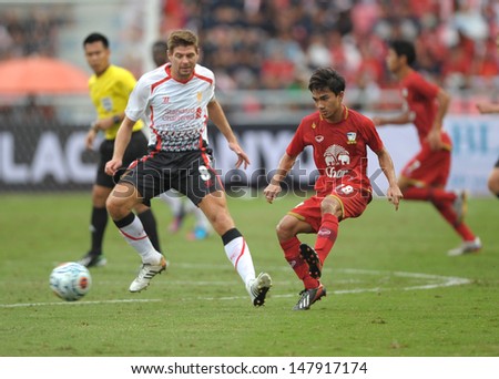 BANGKOK,THAILAND-JULY 28 : Chanatip Songkasin (r) in action during the international friendly match Liverpool FC (W) and Thai National (R) at the Rajamangala Stadium on July 28 ,2013 inThailand.