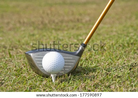 Golf equipment, golf ball with tee on course and stick
