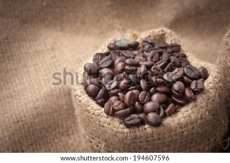 A cup of cafe latte and coffee beans