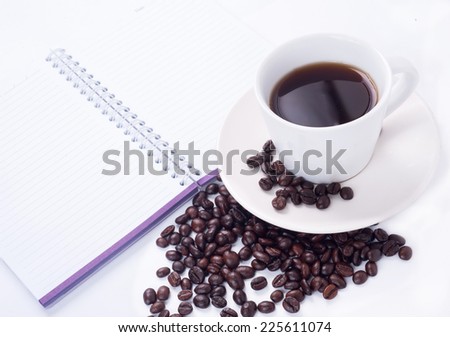 coffee beans and notebook on white background,