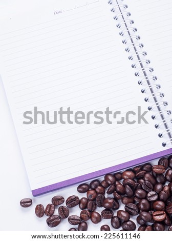 coffee beans and notebook on white background,