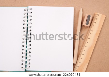 open diary or photo album book on brown background has pencil,eraser ruler