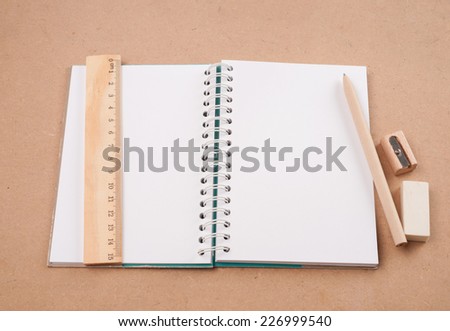 open diary or photo album book on brown backgroun has pencil,eraser ruler