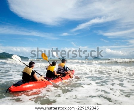 Kayaking. Young is sailing on a sea kayak. Sports and recreation on the water.