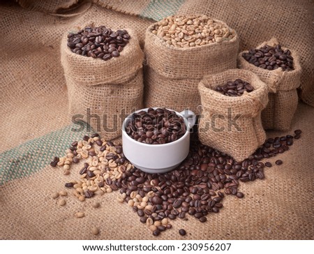 A cup of cafe latte and coffee beans