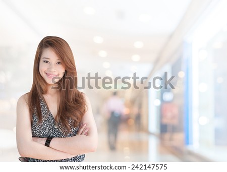 portrait asian businesswoman with long hair has shopping mall background.Mixed Asian / Caucasian businesswoman.