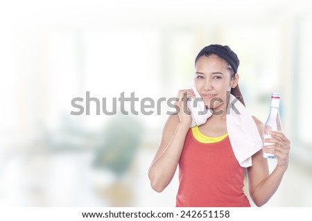 Young beautiful woman during fitness time and exercising , has gym background