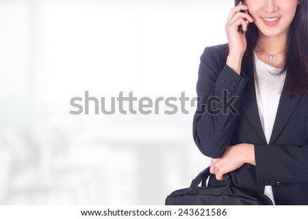 Portrait of young asia business woman use business phone in her office.