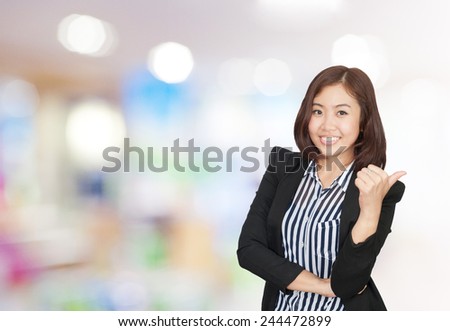 portrait asian businesswoman 20 -30 year old with long hair has shopping mall background.Positive emotion