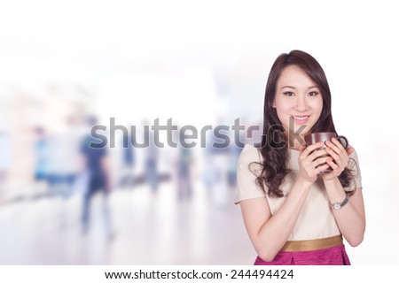 Portrait of young asia business woman 20-30 year old hold coffee cup has people walk background.Mixed Asian / Caucasian businesswoman.Positive emotion