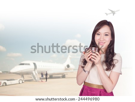Portrait of young asia business woman 20-30 year old hold coffee cup has airport background ..Mixed Asian / Caucasian businesswoman.Positive emotion