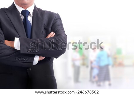 Portrait of young asia businessman has office background .cross one\'s arm,