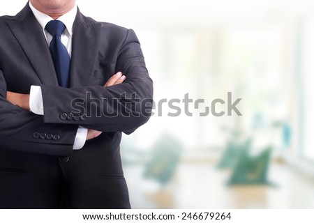 Portrait of young asia businessman has office background .cross one's arm,Positive emotion