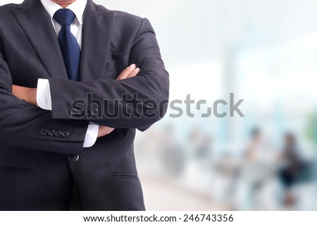 Portrait of young asia business man has office background .cross one's arm,Positive emotion