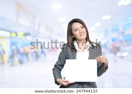 Portrait of young asia business woman 20 -30 year hold banner old in her office.Mixed Asian / Caucasian businesswoman.Positive emotion