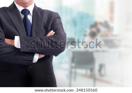 Portrait of young asia business man has office background .cross one\'s arm,Positive emotion