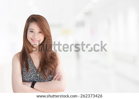 Portrait of asia business woman 20 - 30 year old in her office background .Mixed Asian / Caucasian businesswoman.Positive emotion