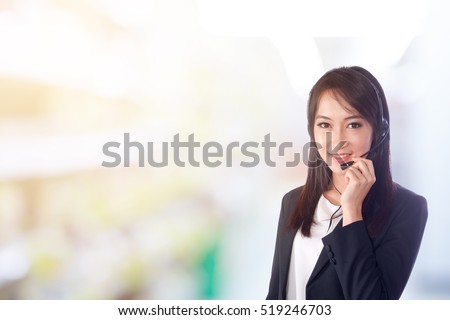 Smiling woman wearing microphone headset as an operator, telemarketer, call center ,hot line and customer service staff.Positive emotion