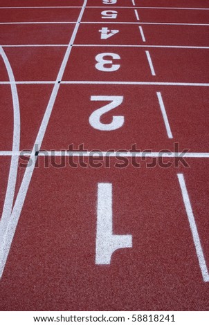 Numbers of a racetrack on red tarmac for runners abstract arena athlete