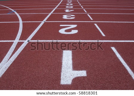 Numbers of a racetrack on red tarmac for runners abstract arena athlete