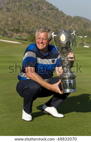 HUA HIN, THAILAND - JANUARY 9: Colin Montgomerie lifting the trophy after winning the Royal Trophy tournament at Black Mountain Golf Club Hua Hin Thailand on January 9, 2011.