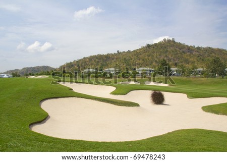 Golf: sand trap on the green grass