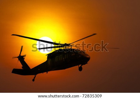 Helicopter landing at sunset