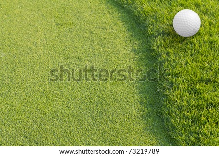 Golf ball on green tee