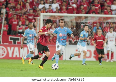 BANGKOK- APR 17 :N.Arromsawa(red) in action during Thai Premier League (TPL) between Muang Thong utd (Red) vs SCG Samutsongkram Fc (Blue) on April 17, 2011 at  Yamaha Stadium Bangkok, Thailand