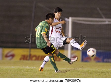 BANGKOK THAILAND- APRIL 24: J.Sungpong (green) in action during Thai Premier League (TPL) between Army Utd. (green) vs Insee Police Utd. (white) on April 24, 2011 at Army Stadium in Bangkok Thailand