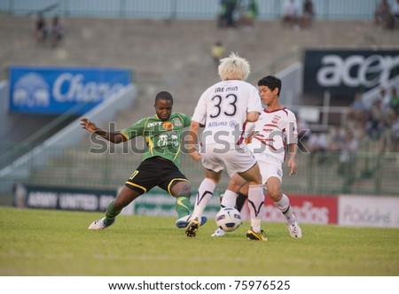 BANGKOK, THAILAND - APRIL 24: R.Santana (green) in action during Thai Premier League (TPL) between Army Utd. (green) vs Insee Police Utd. (white) on April 24, 2011 at Army Stadium in Bangkok Thailand